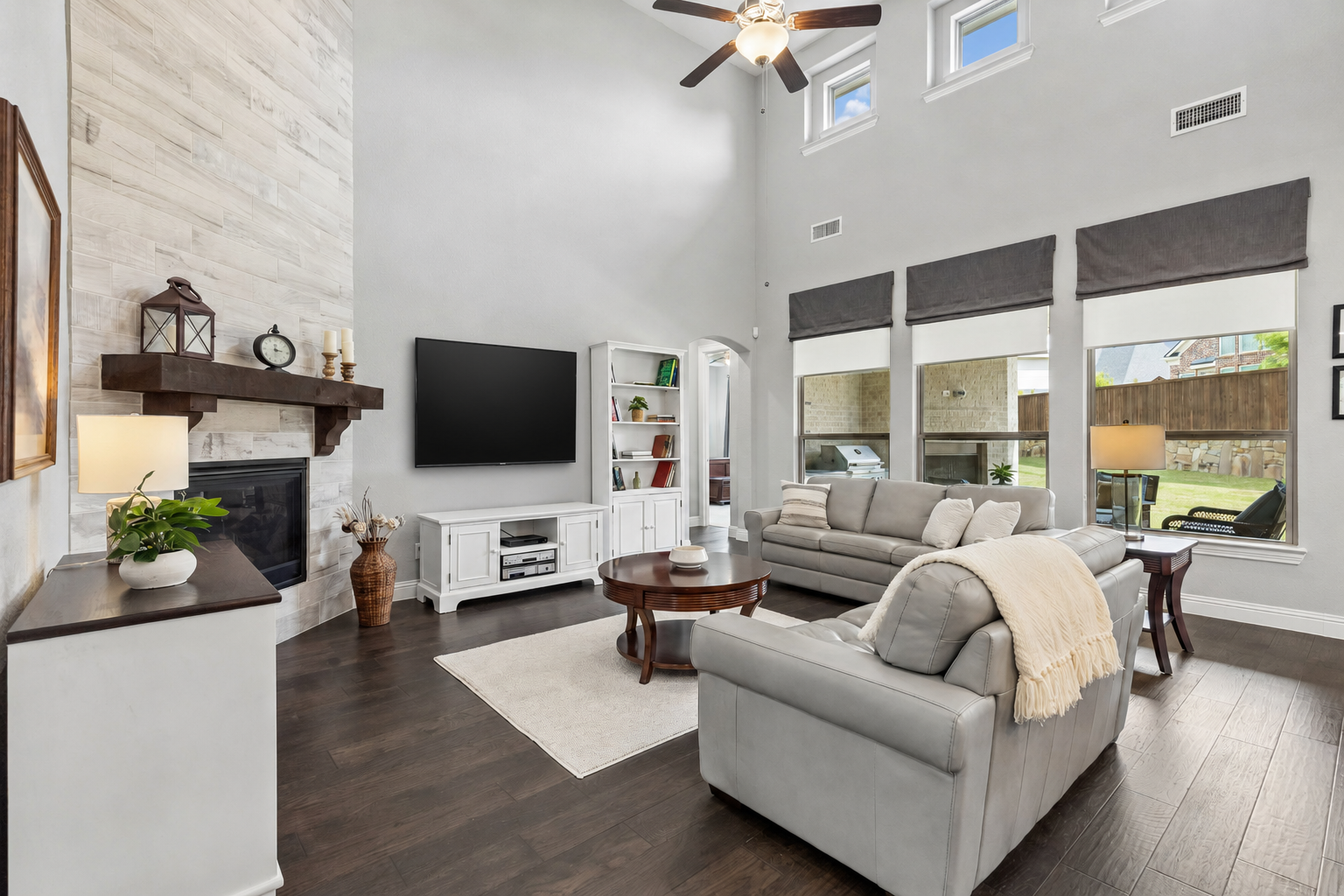 Two-story family room with floor-to-ceiling fireplace and clerestory windows