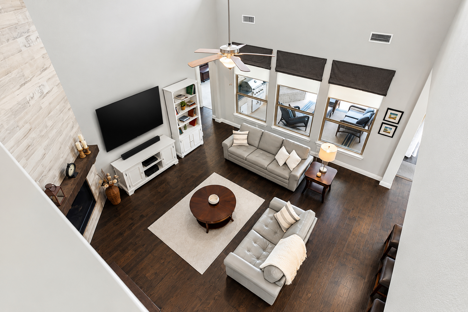 Top-down view from upstairs overlook into two-story family room
